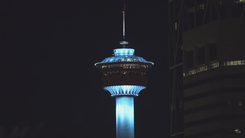 Calgary Tower lit up in various colours