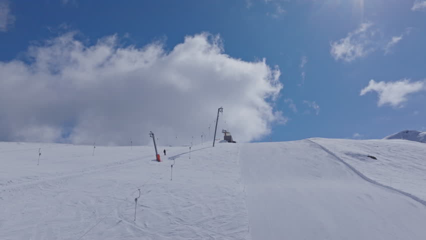 High performance alpine ski carving on groomed pistes in Verbier Bruson and Val de Bagnes filmed with drone and follow cam on a bluebird winter day showcasing fast dynamic fun skiing.