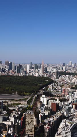 Tokyo, Japan, beautiful super wide aerial view of rooftops and skyscrapers, with skyline and city wards scenery, from the observation deck in a sunny day with a blue sky, Tokyo Metropolitan urban area