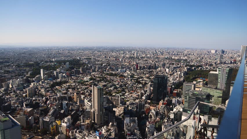 Tokyo, Japan, beautiful super wide aerial view of rooftops and skyscrapers, with skyline and city wards scenery, from the observation deck in a sunny day with a blue sky, Tokyo Metropolitan urban area