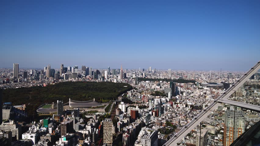 Tokyo, Japan, beautiful super wide aerial view of rooftops and skyscrapers, with skyline and city wards scenery, from the observation deck in a sunny day with a blue sky, Tokyo Metropolitan urban area