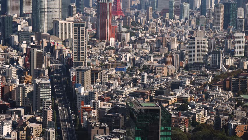 Tokyo, Japan, beautiful super wide aerial view of rooftops and skyscrapers, with skyline and city wards scenery, from the observation deck in a sunny day with a blue sky, Tokyo Metropolitan urban area