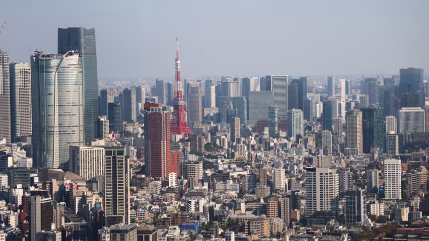 Tokyo, Japan, beautiful super wide aerial view of rooftops and skyscrapers, with skyline and city wards scenery, from the observation deck in a sunny day with a blue sky, Tokyo Metropolitan urban area