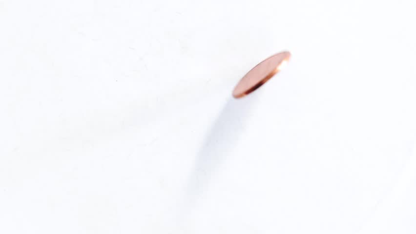 Slow Motion Close-Up of Shiny Copper Penny Spinning on White Background