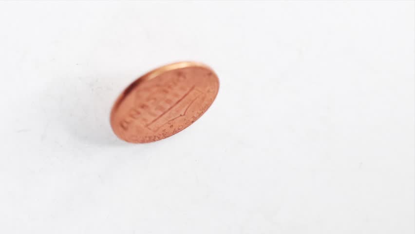 Shiny Copper Penny One Cent Coin Spinning and Wobbling on Surface - Heads or Tails Chance