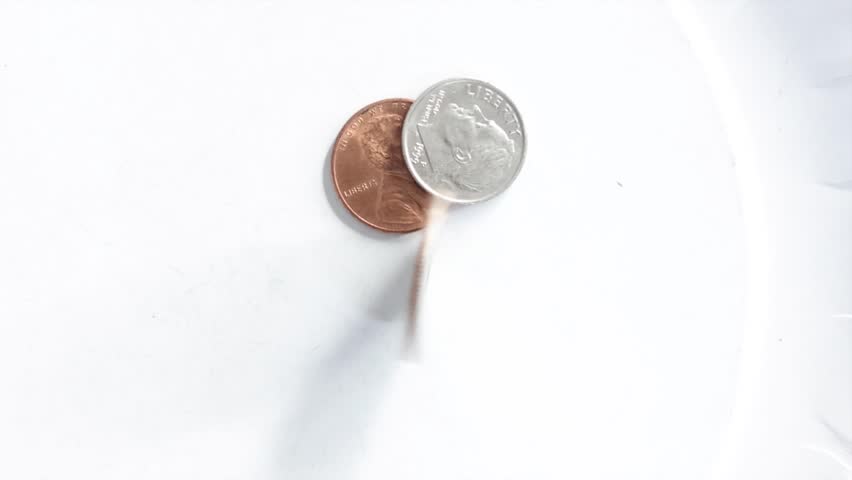 Quarter Spinning in Slow Motion Macro Close-Up on White Background