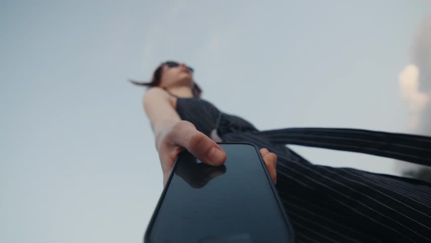 Low angle of a woman using smartphone on a beach
