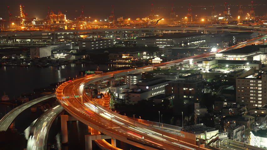 Long exposure light trails on a curved elevated highway at night. Time lapse.