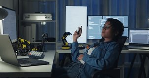 Young African American female programmer coding AI software on multiple screens in night office. Network security, cybersecurity, machine learning, working late, overtime, robotics automation concept. - Powered by Shutterstock - Get 15% off with code: PIKWIZARD15