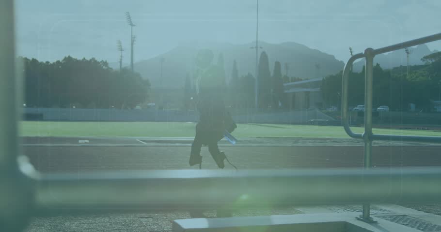 Animation of social distancing over african american man with running blade training at stadium. Disability, active lifestyle and digital interface concept digitally generated video.