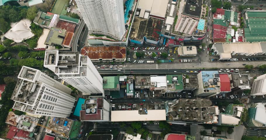 Flying over the residential buildings and highways in Makati, Metro Manila. Philippines.