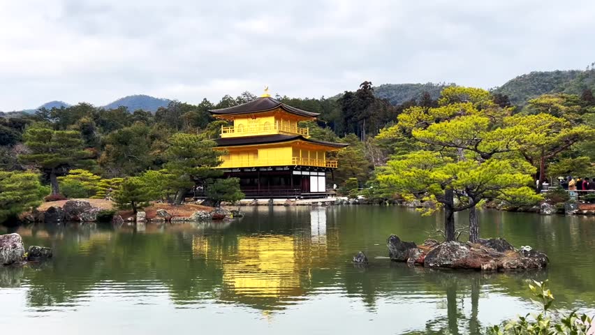 Kinkaku-ji (Golden Pavilion) in Kyoto, Japan, reflecting on a calm pond surrounded by lush greenery. Iconic Buddhist temple and UNESCO World Heritage Site, symbolizing Japanese culture, history, and serene spiritual beauty.