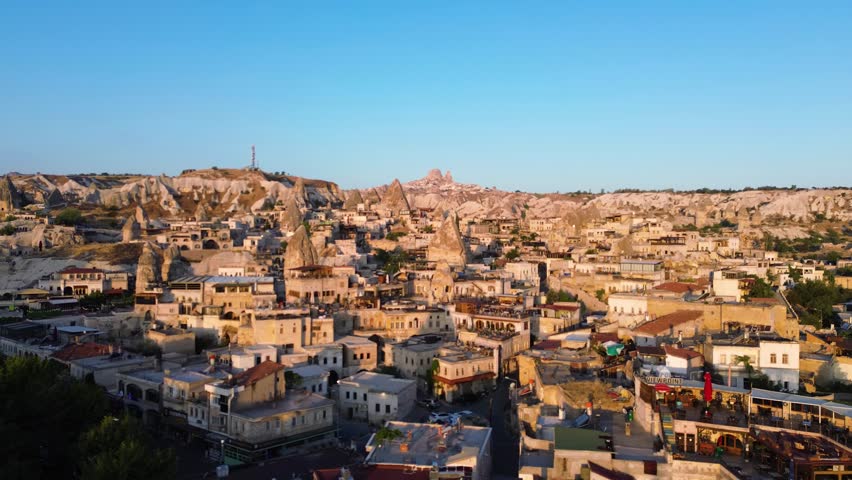 Aerial View of Cappadocia City at Sunset with Traditional Stone Houses, Turkey