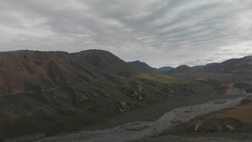 Aerial view of winding road and a bus through Alaskan wilderness Denali National Park