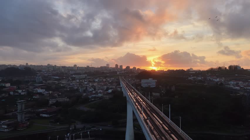 Cars driving on bridge at sunset in Porto, Portugal