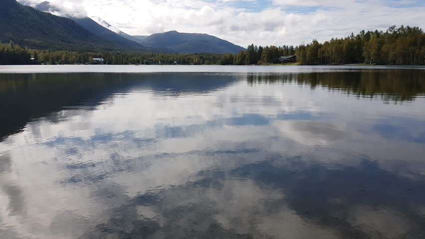 Tilt up view of Mirror Lake with reflection in the Alaskan wilderness