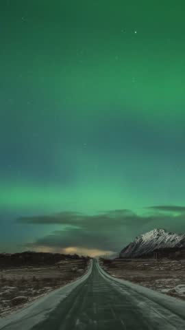 Lofoten Norway time lapse of the aurora borealis northern lights winter landscape at E10 road in Grundstad (vertical)