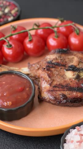 Steak, beef or pork on the bone, meat cooked on the grill with rosemary, salt and spices. Steak on the bone as a food background for your design