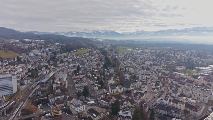 Aerial view of a picturesque town in Canton Zurich, Switzerland with mountains on the background. Ruti ZH, Switzerland. 