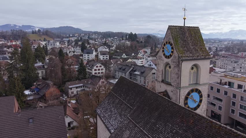 Old church with a tall clock tower in Zurich canton, aerial shot of historic European architecture. Ruti ZH, Switzerland