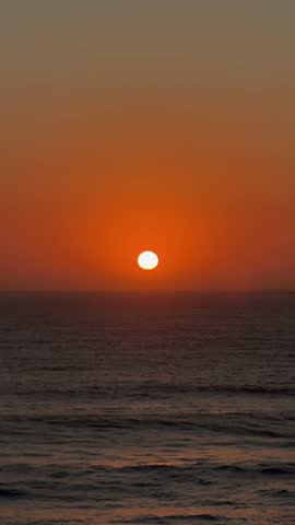 Glowing Orange Sun Setting Over Atlantic Ocean.

Powerful sunset scene with bright orange sun and reflections over the Atlantic Ocean.