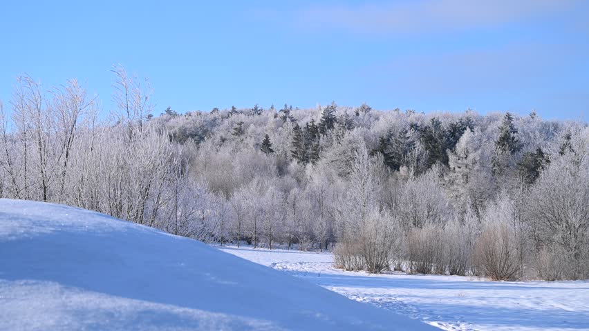 Winter snowy rural landscape, mountainous landscape, snow-covered trees, sunny day