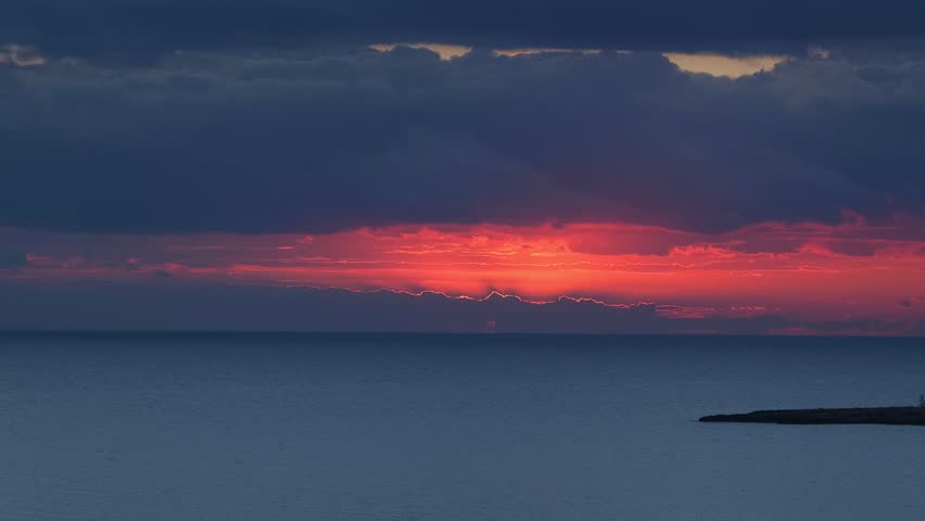 Sunrise Over Calm Sea. Early Morning Sun Rising Over Tranquil Sea Horizon. Peaceful Ocean Sunrise with Soft Purple Light. Seascape at Sunrise with Glowing Sky Reflection