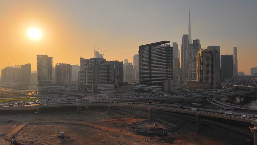 Aerial view of Dubai skyline and highways at sunset, United Arab Emirates