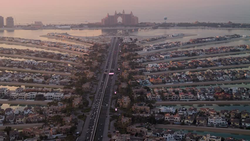Time lapse of traffic and villas on Palm Jumeirah island at dusk, Dubai, UAE