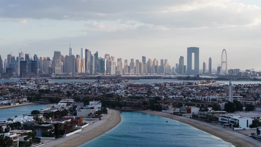Aerial view of Palm Jumeirah villas with Dubai Marina skyline, UAE