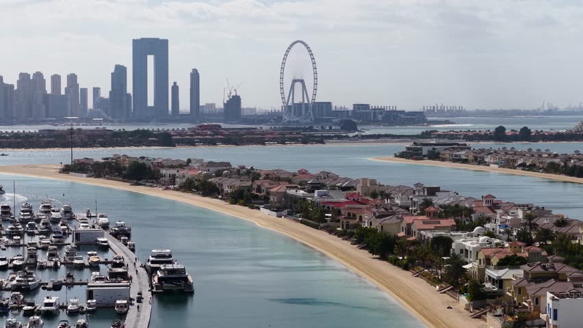 Drone shot of Palm Jumeirah villas with Dubai Marina skyline, UAE