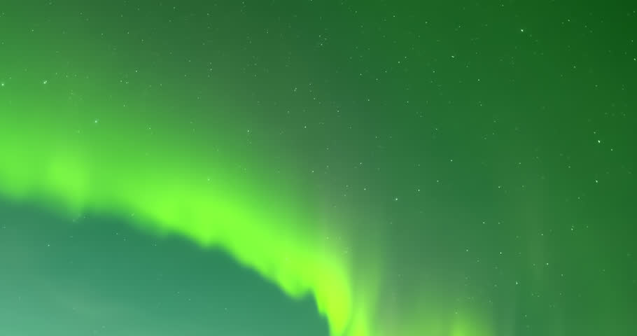 Mesmerizing time lapse of vivid northern lights dancing across a starry night sky above a dark horizon, vibrant green and teal waves creating cosmic motion perfect for nature, travel, atmospheric and stock footage visuals.