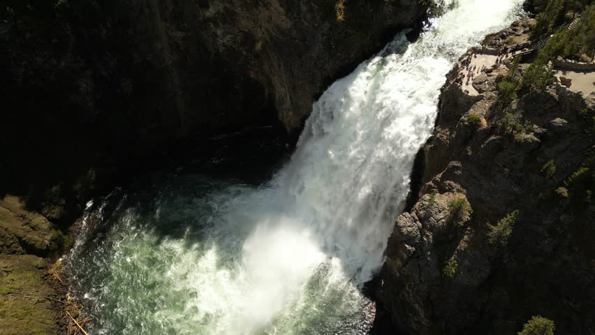 Cinematic drone pullaway reveal of mountain waterfall landscape