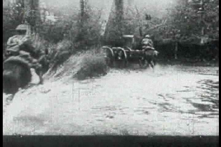 1910s - British troops fire cannons on the battlefield in World War One, 1917.