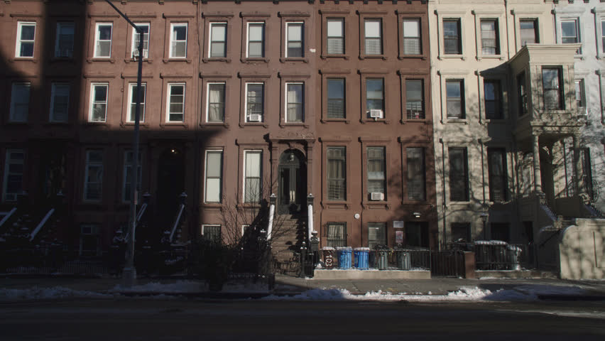 Handheld shot of a row of residential buildings in New York City. Shot on a winter day.