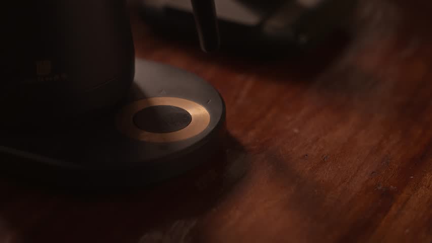 Close up hand of  woman setting the temperature on an electric kettle.