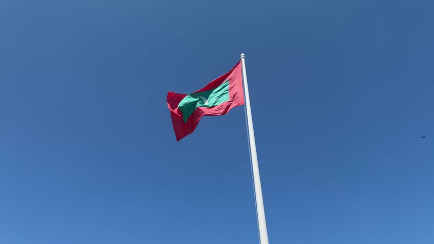 Maldives big flag blowing in the wind in male Malé capital city