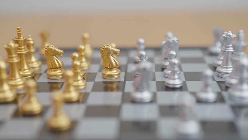 hand moving gold Chess knight figure and Checkmate opponent during chessboard competition. Strategy, Success, management, business planning, win, disruption, Trade war and leadership concept