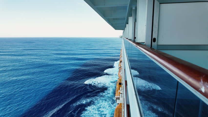 Smooth forward-moving view of the open ocean filmed from a cruise ship balcony, creating a calm travel and journey atmosphere