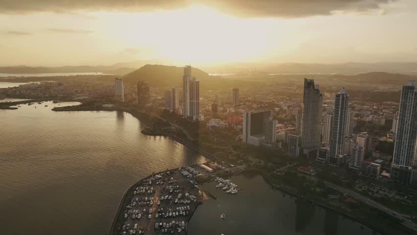 Aerial drone shot at high altitude showing Panama City during sunset
