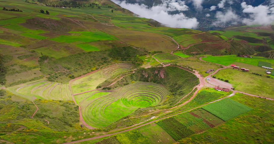 Moray Inca agricultural terraces forming circular patterns in the Andes, aerial panoramic establishing