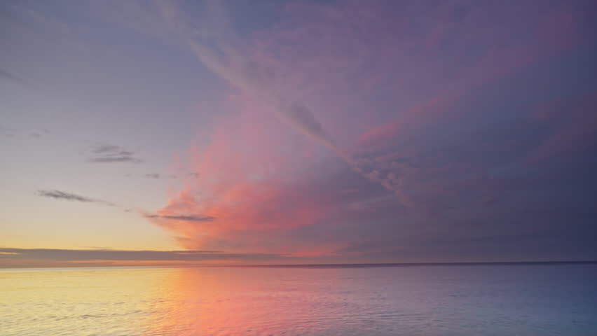 Epic sunset on the sea sandy shore. Calm and zen nature scene. Color graded to Rec.709 from 10-bit Log source for maximum dynamic range. 