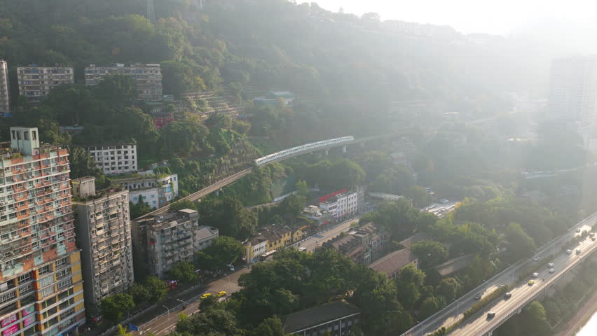 Monorail Transit Train Passing Through Liziba Station In Chongqing, China. Aerial Shot