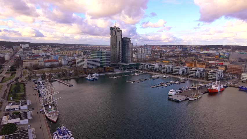 Aerial establishing shot of gdynia port marina in poland, with the sea towers residential building and skwer kosciuszki waterfront