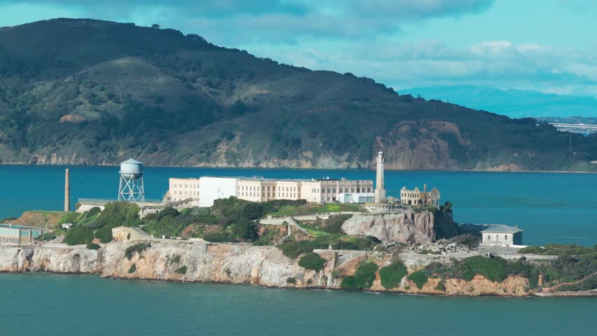 Telephoto panning aerial shot of Alcatraz Island in the middle of San Francisco Bay in Northern California. 4K