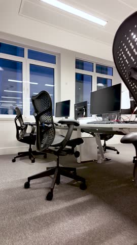 Modern Empty Office Interior With Black Ergonomic Chairs And Desks Near Windows Showing Workplace Environment For Business And Corporate Concepts.vertical video