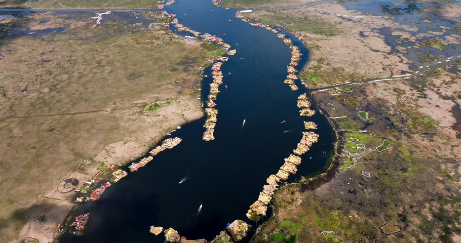 Uros floating islands on Lake Titicaca in Puno, Peru. Unique indigenous settlement and South American landmark. Aerial drone high angle