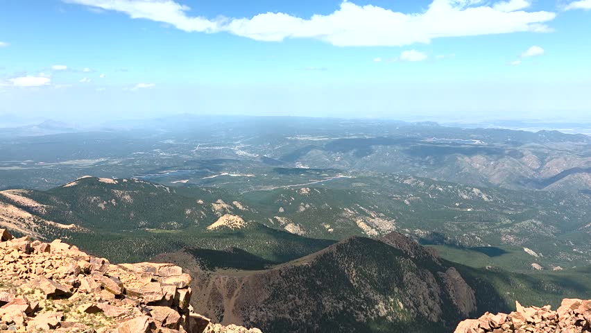 Pikes Peak panoramic vista showcasing mountains, valleys, and distant landscape from the summit, bringing an inspiring view of wilderness and adventure in Colorado, USA