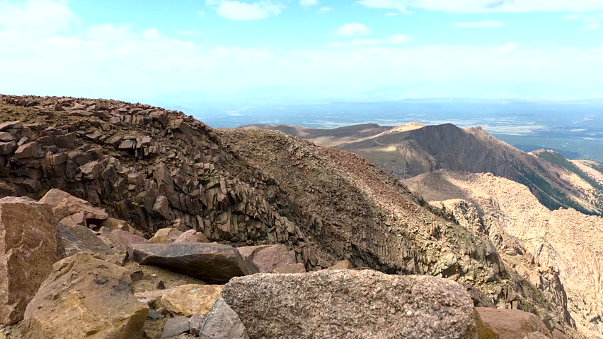 Pikes Peak summit vista revealing rugged alpine terrain and distant horizon, showcasing Colorado