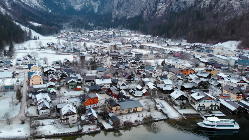 Captain Readies Vessel Near Icy Shoreline. Peaceful Scene Of Boat Beside Snowcovered Town And Lake. Media